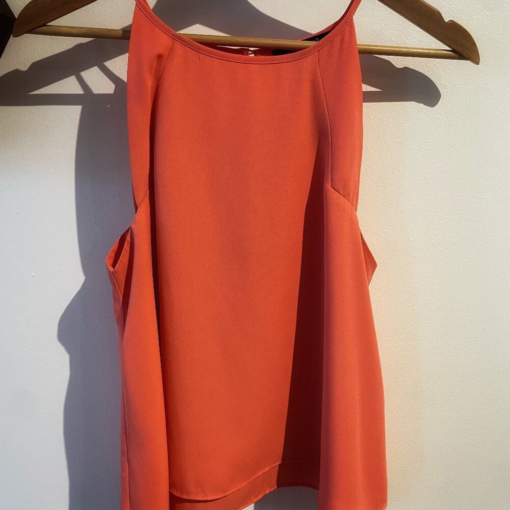 Short orange strapless blouse with a beautiful drape.